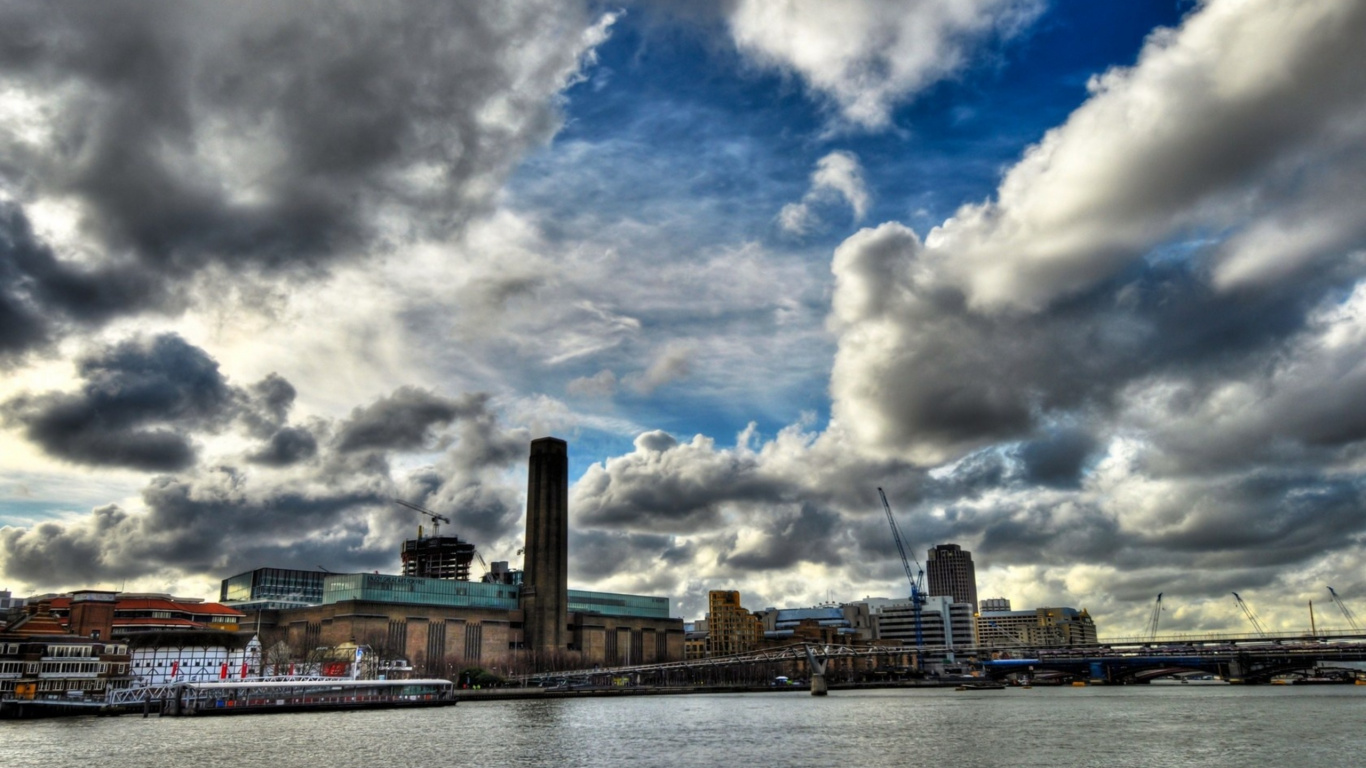 White and Brown Concrete Building Near Body of Water Under White Clouds and Blue Sky During. Wallpaper in 1366x768 Resolution