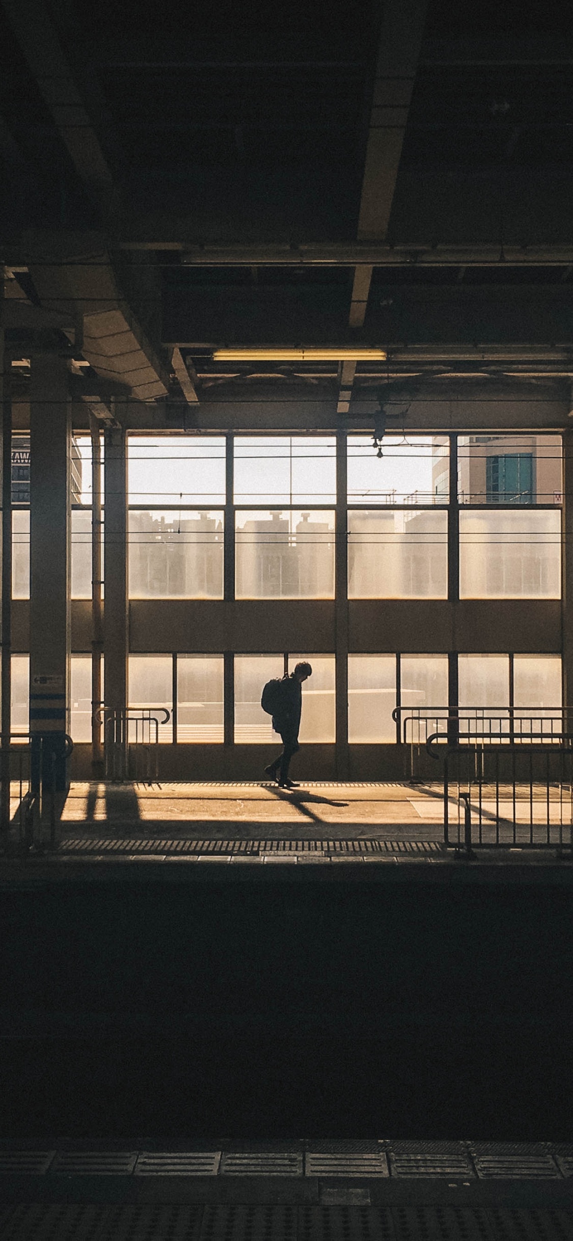 Silhouette of Person Walking on Sidewalk During Daytime. Wallpaper in 1125x2436 Resolution