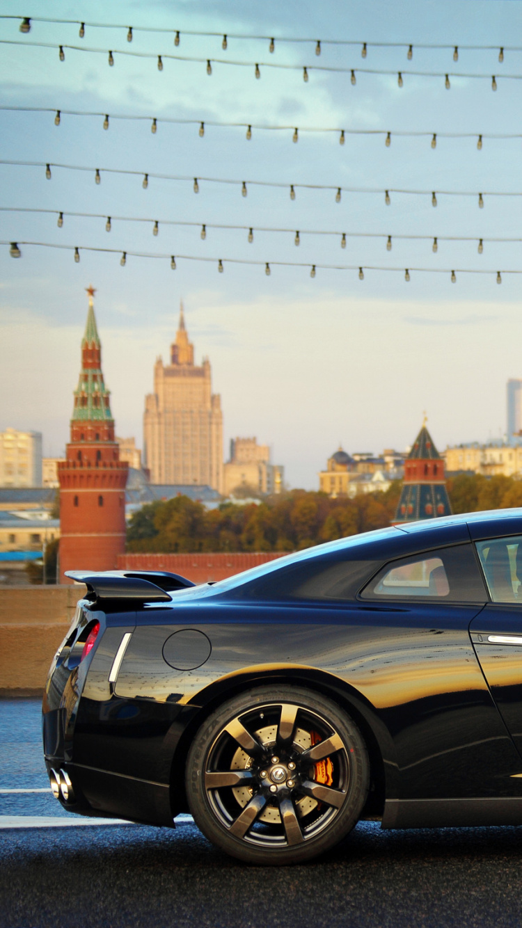 Black Coupe Parked on The Side of The Road. Wallpaper in 750x1334 Resolution