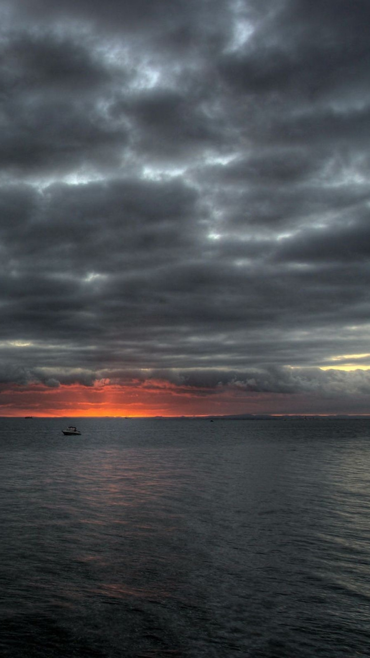 Body of Water Under Cloudy Sky During Sunset. Wallpaper in 750x1334 Resolution