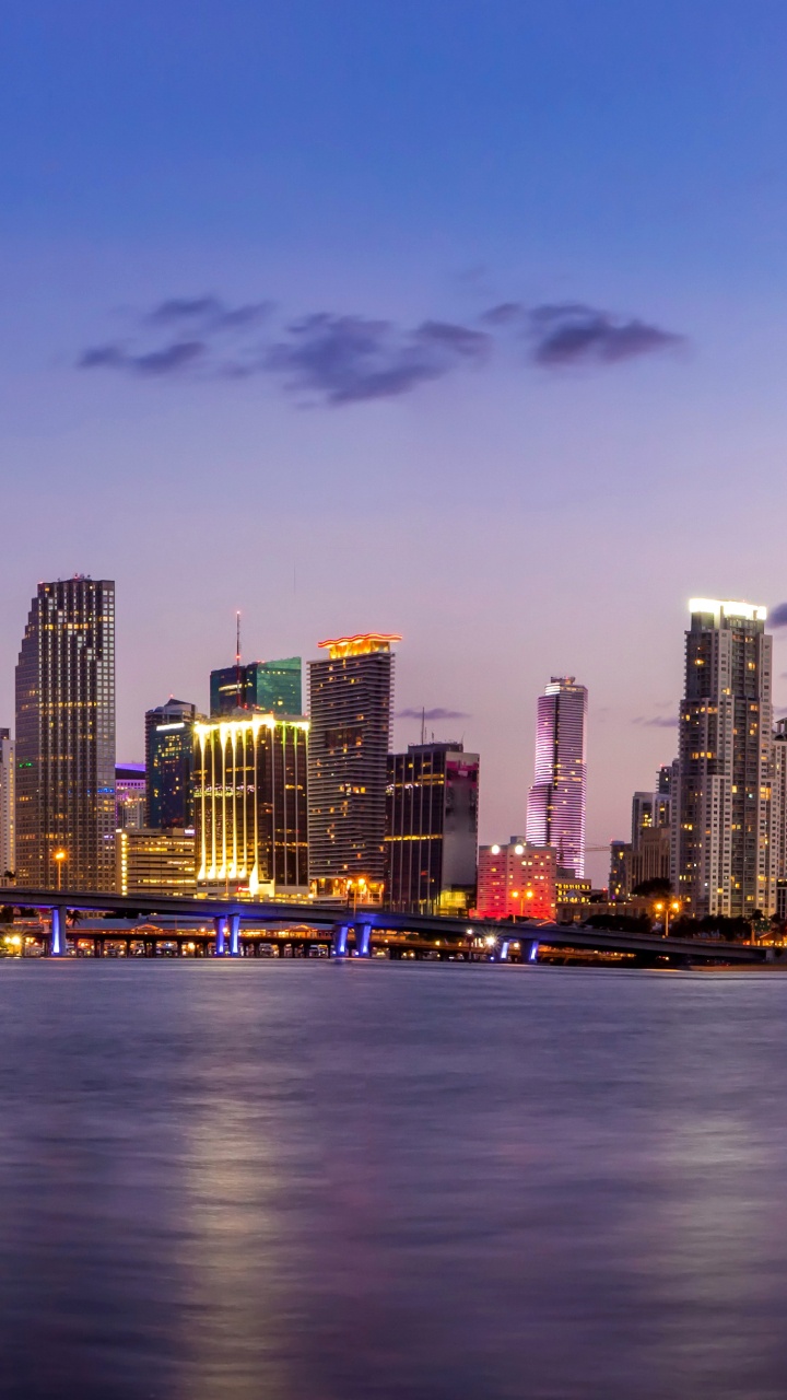 City Skyline Across Body of Water During Night Time. Wallpaper in 720x1280 Resolution