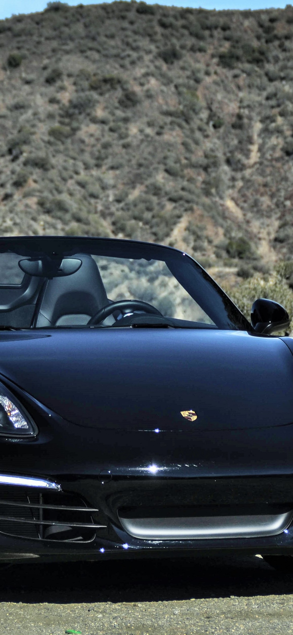 Black Porsche 911 on Brown Dirt Road During Daytime. Wallpaper in 1125x2436 Resolution