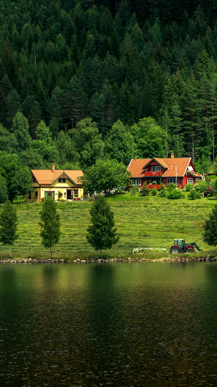Brown House on Green Grass Field Near Lake During Daytime. Wallpaper in 720x1280 Resolution