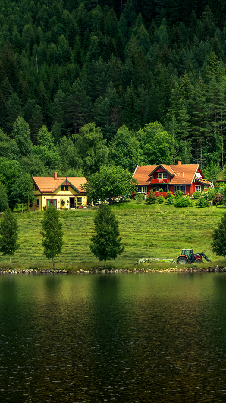 Brown House on Green Grass Field Near Lake During Daytime. Wallpaper in 750x1334 Resolution