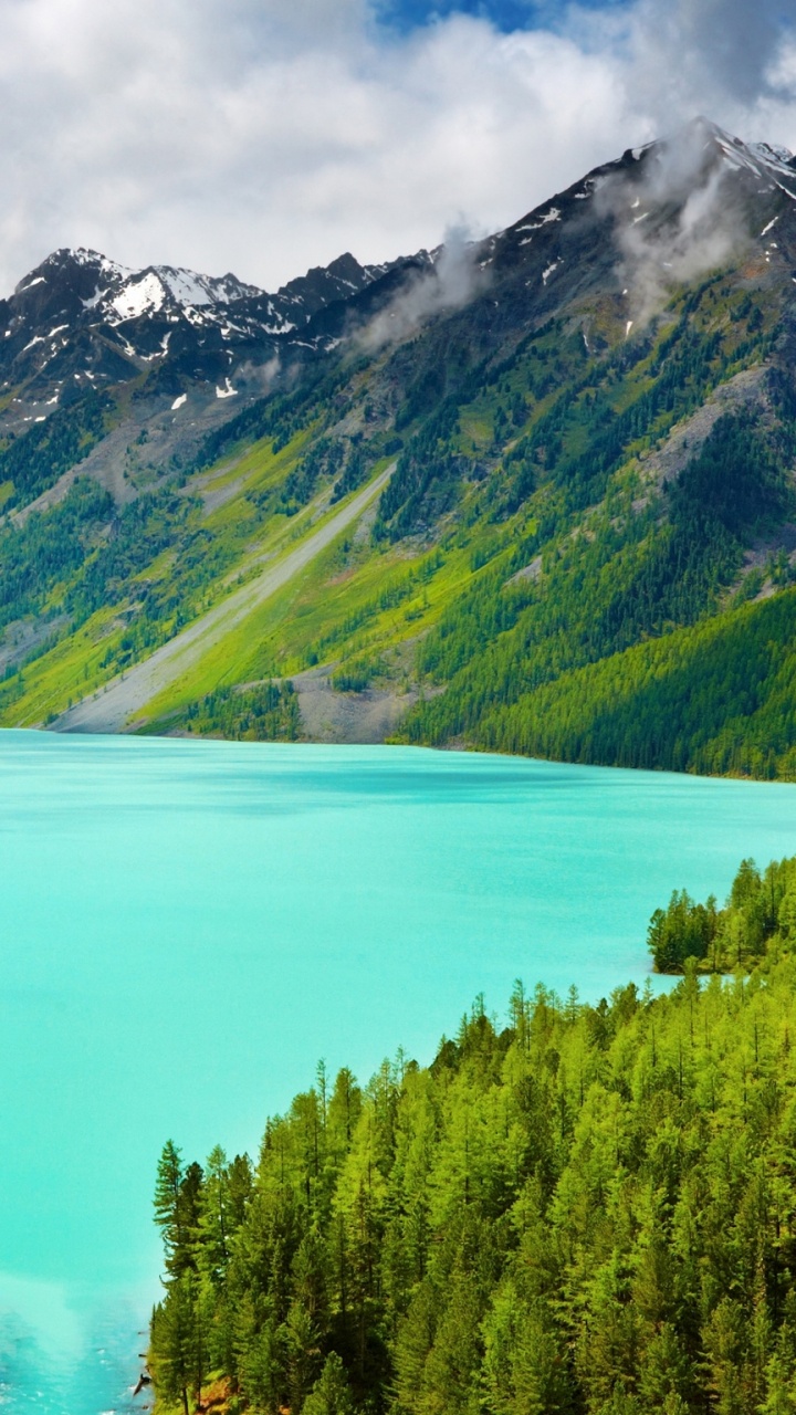 Green Mountains Near Lake Under Blue Sky During Daytime. Wallpaper in 720x1280 Resolution