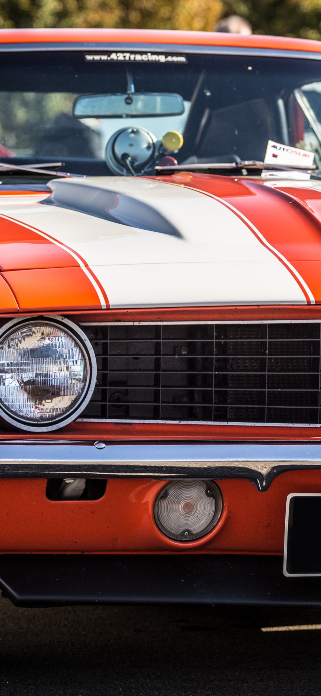 Red and Black Chevrolet Camaro. Wallpaper in 1125x2436 Resolution