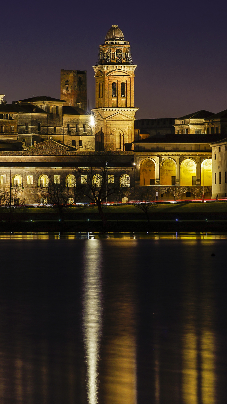 White Concrete Building Near Body of Water During Night Time. Wallpaper in 750x1334 Resolution