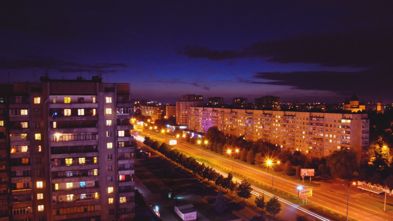 Cars on Road Near High Rise Buildings During Night Time. Wallpaper in 1366x768 Resolution