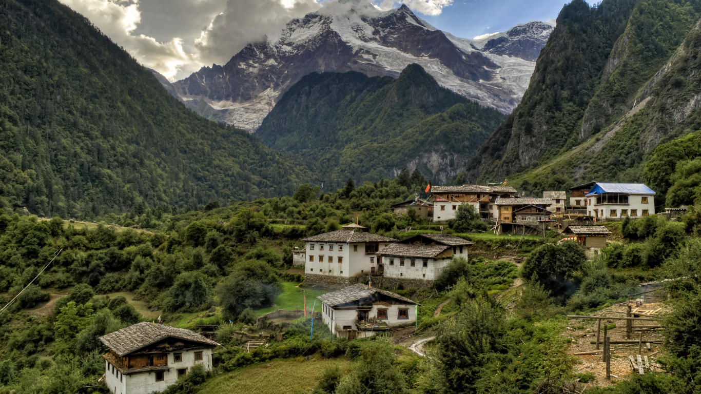White and Brown Concrete Building Near Green Trees and Mountains During Daytime. Wallpaper in 1366x768 Resolution