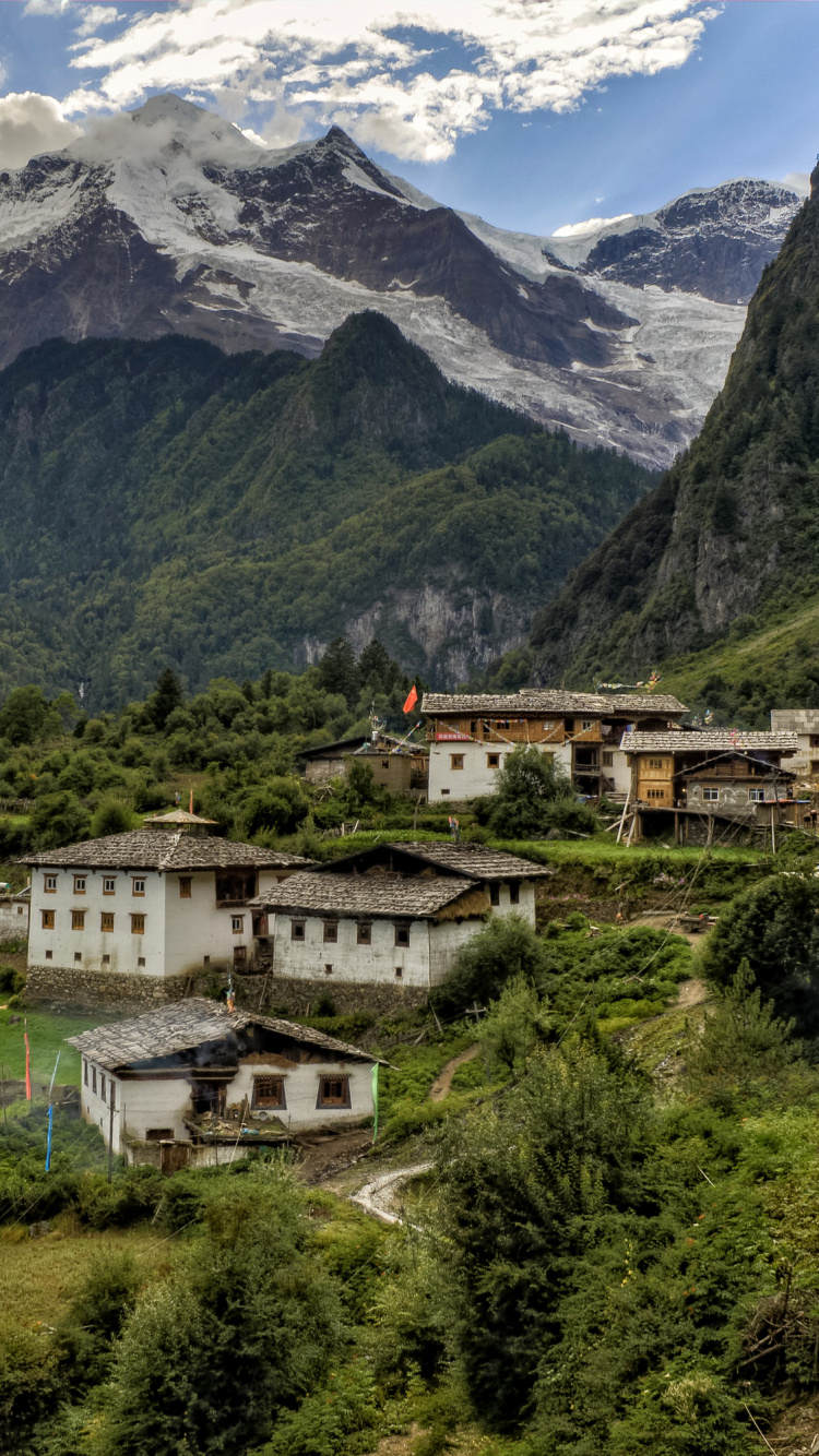 White and Brown Concrete Building Near Green Trees and Mountains During Daytime. Wallpaper in 750x1334 Resolution