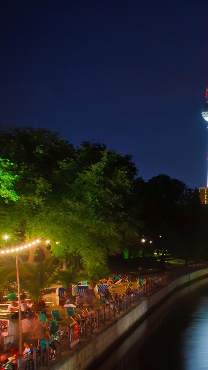 Bâtiment en Béton Brun Près D'un Plan D'eau Pendant la Nuit. Wallpaper in 720x1280 Resolution