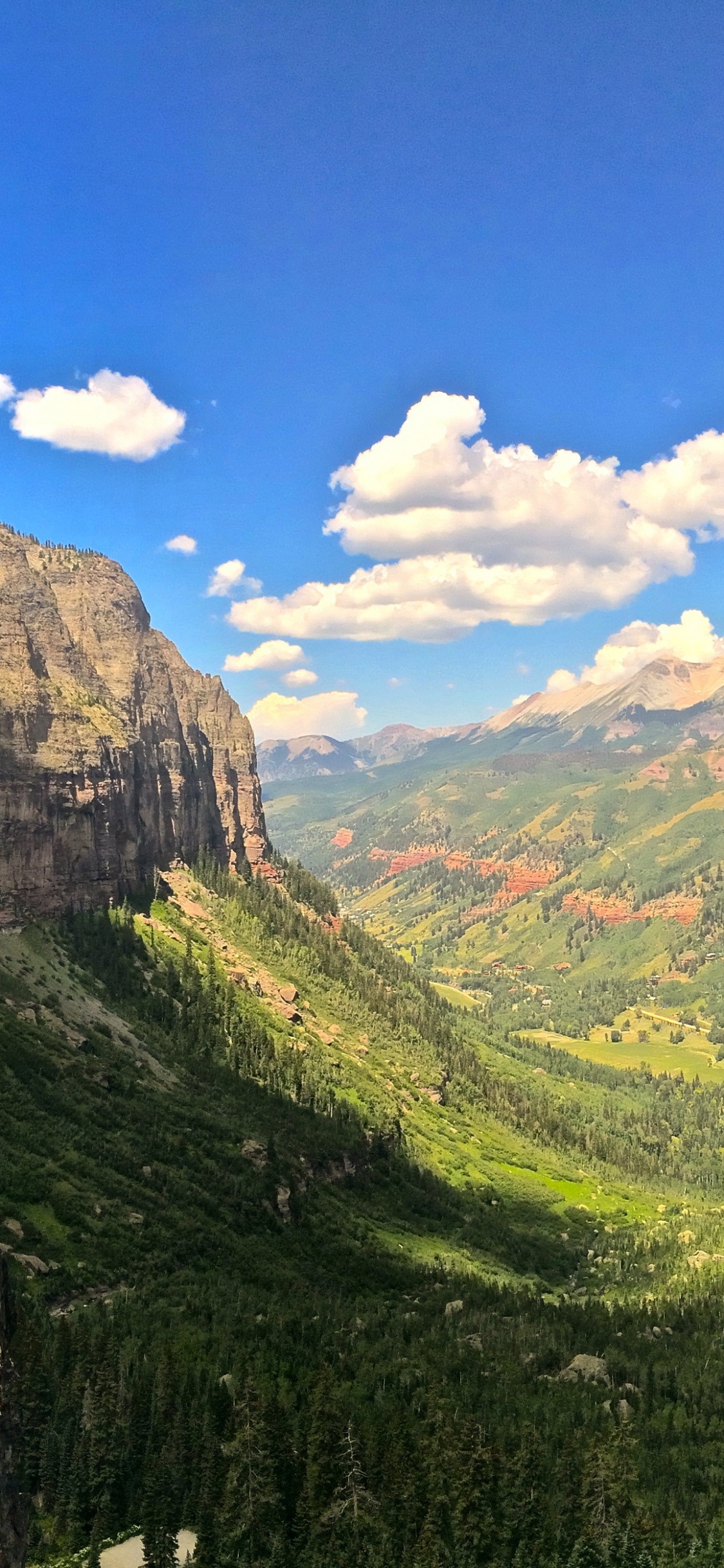 Green Mountains Under Blue Sky During Daytime. Wallpaper in 1125x2436 Resolution