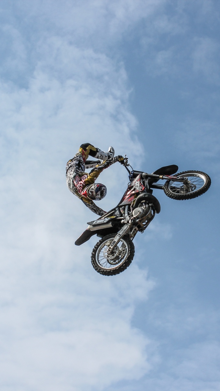 Man Riding on Bicycle Doing Stunts Under Blue Sky During Daytime. Wallpaper in 720x1280 Resolution