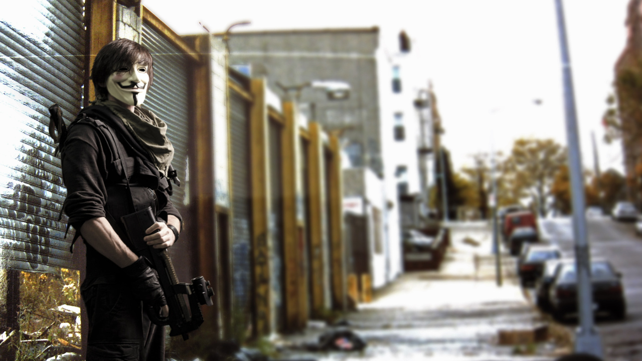 Woman in Black Jacket Holding Black Dslr Camera Standing on Sidewalk During Daytime. Wallpaper in 1280x720 Resolution