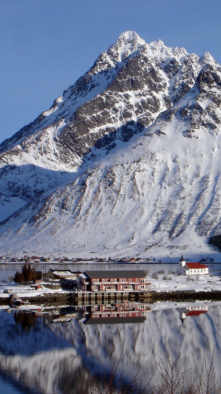 White and Brown House Near Snow Covered Mountain During Daytime. Wallpaper in 720x1280 Resolution