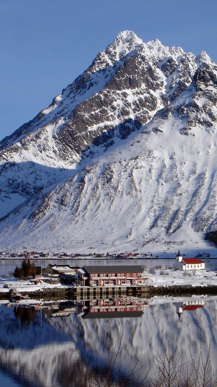 White and Brown House Near Snow Covered Mountain During Daytime. Wallpaper in 750x1334 Resolution