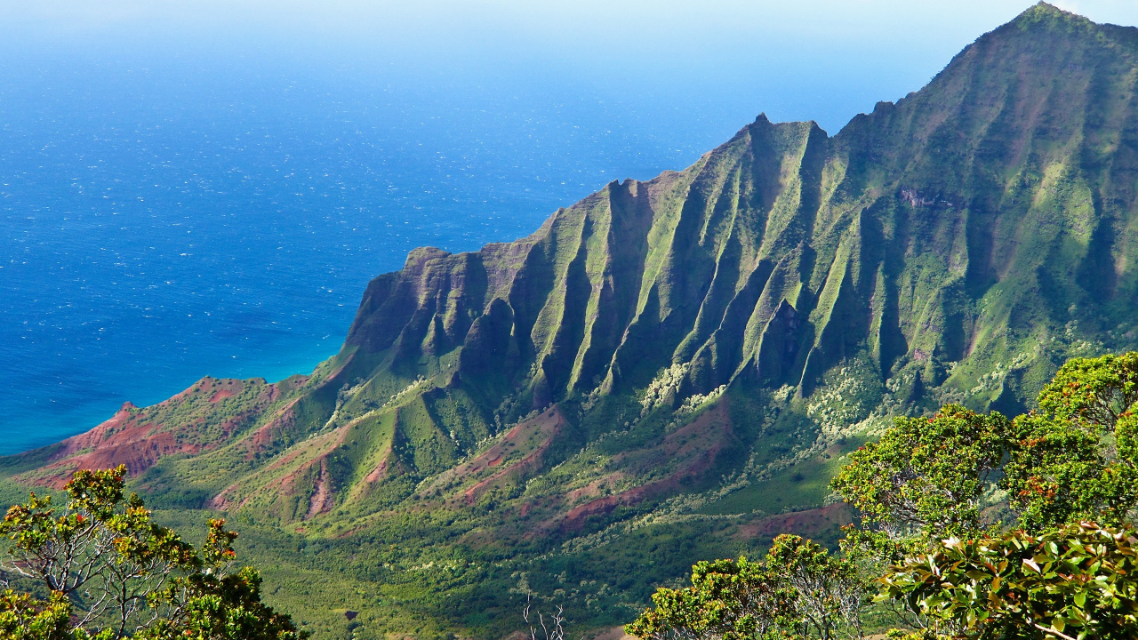 Green and Brown Mountains Beside Blue Sea Under Blue Sky During Daytime. Wallpaper in 1280x720 Resolution