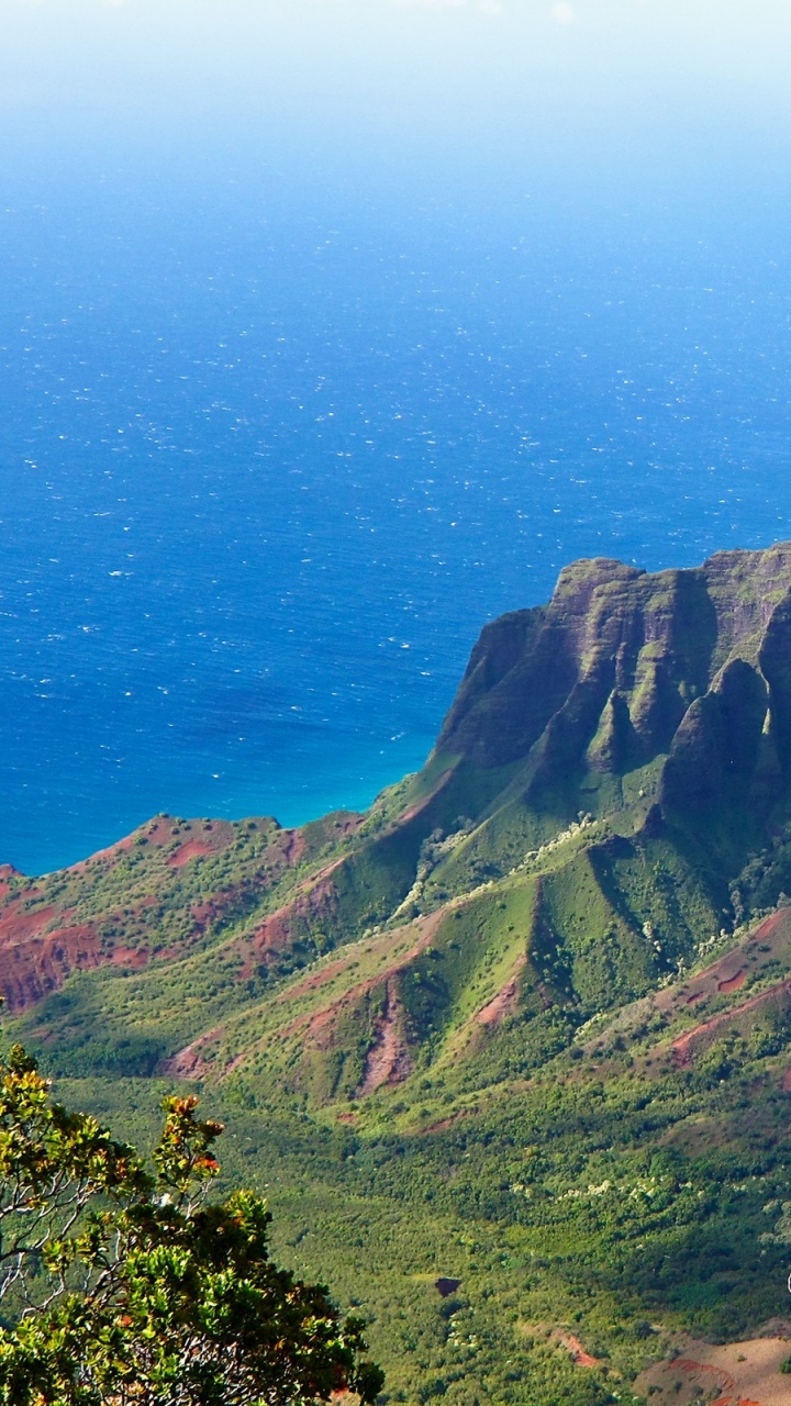 Green and Brown Mountains Beside Blue Sea Under Blue Sky During Daytime. Wallpaper in 720x1280 Resolution