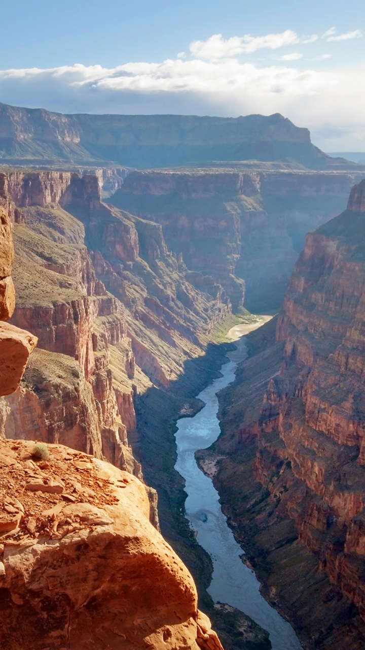 Brown Rocky Mountain Near River During Daytime. Wallpaper in 720x1280 Resolution