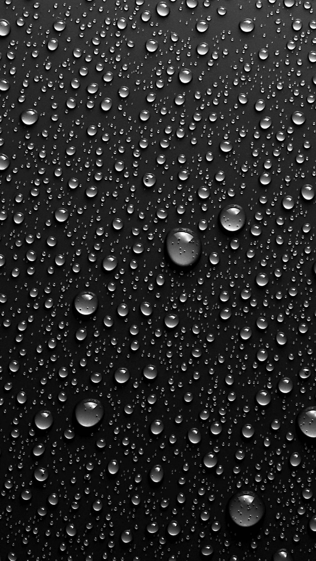 Water Droplets on Black Surface. Wallpaper in 1080x1920 Resolution