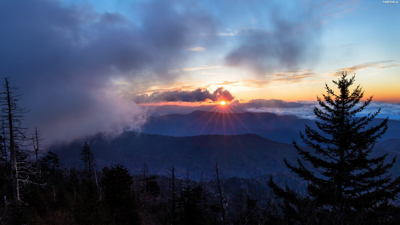 Silhouette of Trees and Mountains Under Cloudy Sky During Sunset. Wallpaper in 1366x768 Resolution