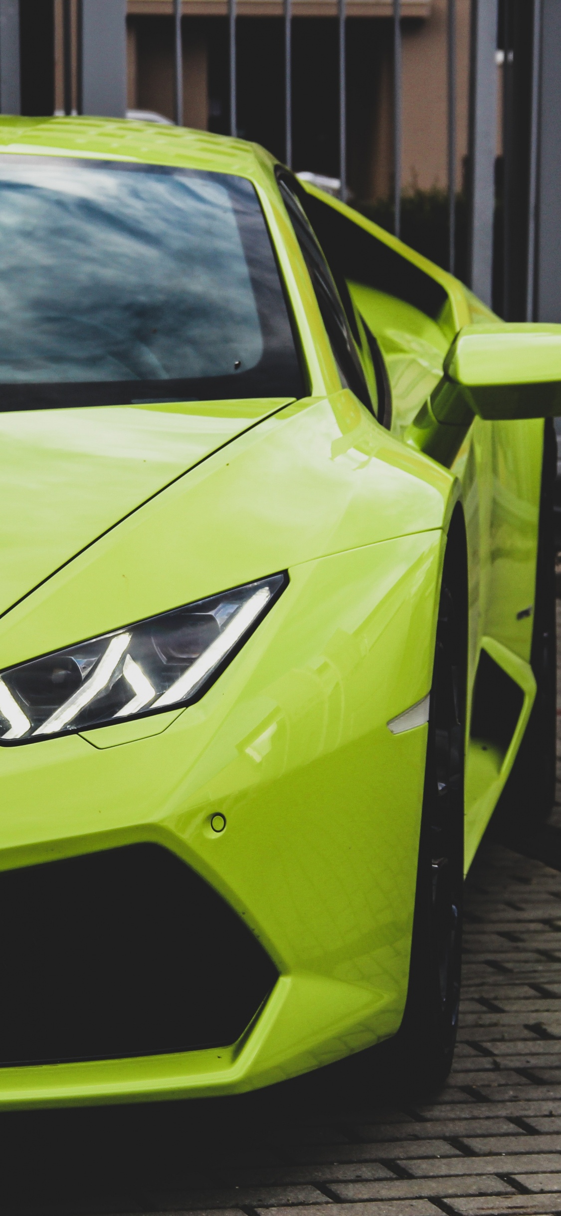 Green Lamborghini Aventador Parked on Street During Daytime. Wallpaper in 1125x2436 Resolution