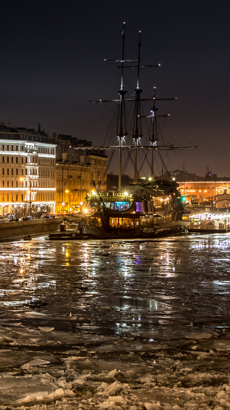 White Concrete Building Near Body of Water During Night Time. Wallpaper in 750x1334 Resolution