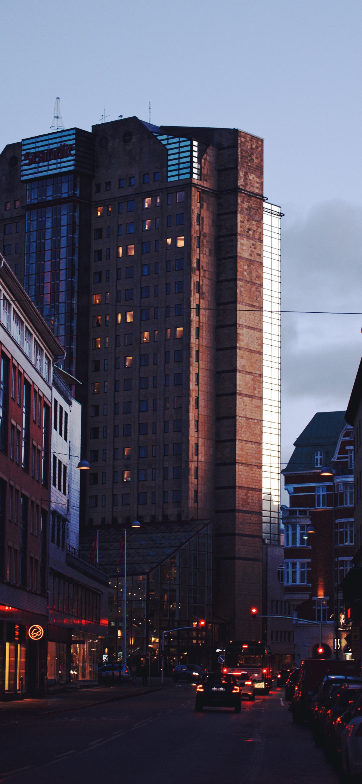 Cars on Road Between High Rise Buildings During Daytime. Wallpaper in 1242x2688 Resolution