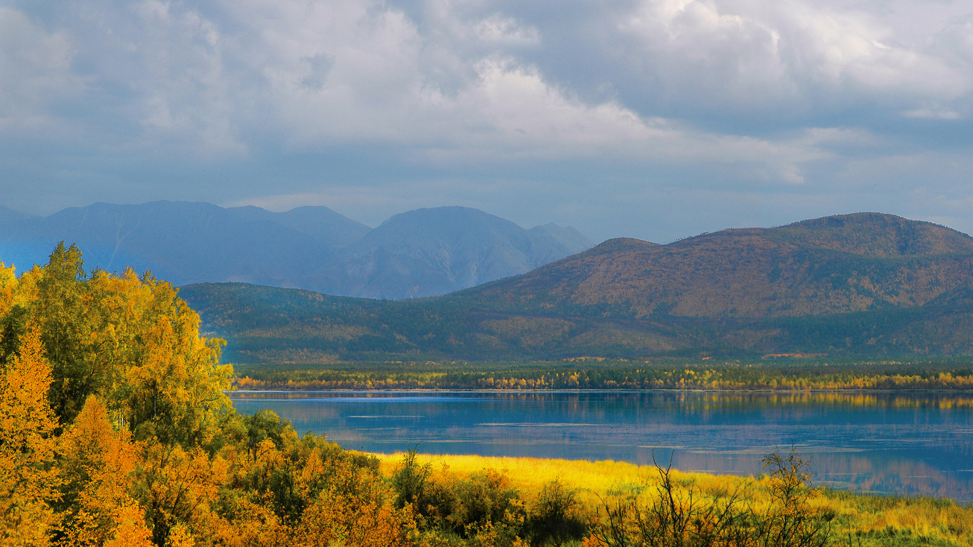 Green Mountains Near Body of Water Under Cloudy Sky During Daytime. Wallpaper in 1920x1080 Resolution