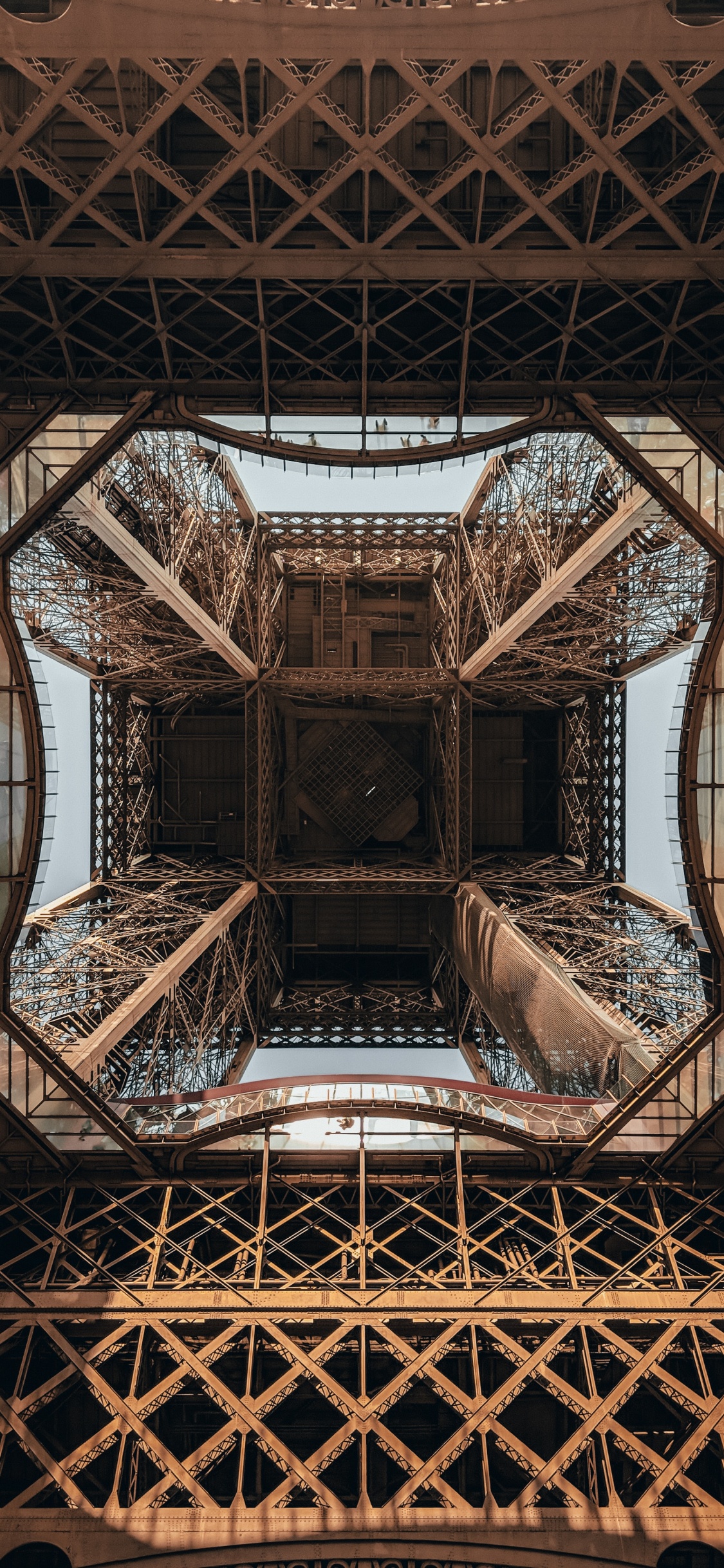 Man in Black T-shirt and Blue Denim Jeans Sitting on Brown Wooden Chair. Wallpaper in 1125x2436 Resolution