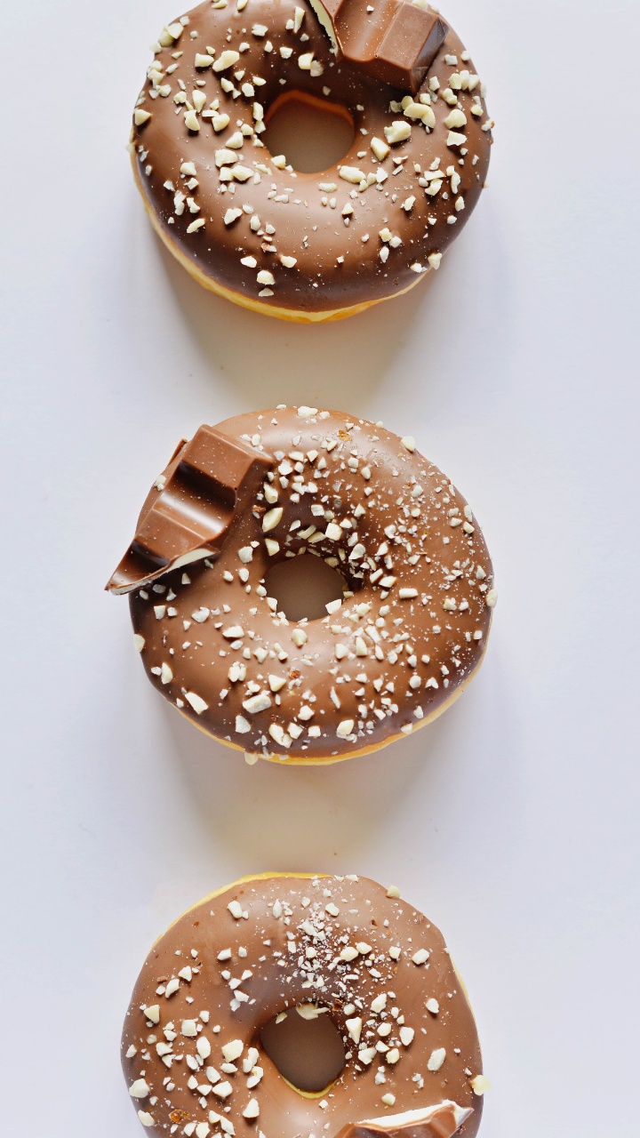 Brown Donut on White Table. Wallpaper in 720x1280 Resolution