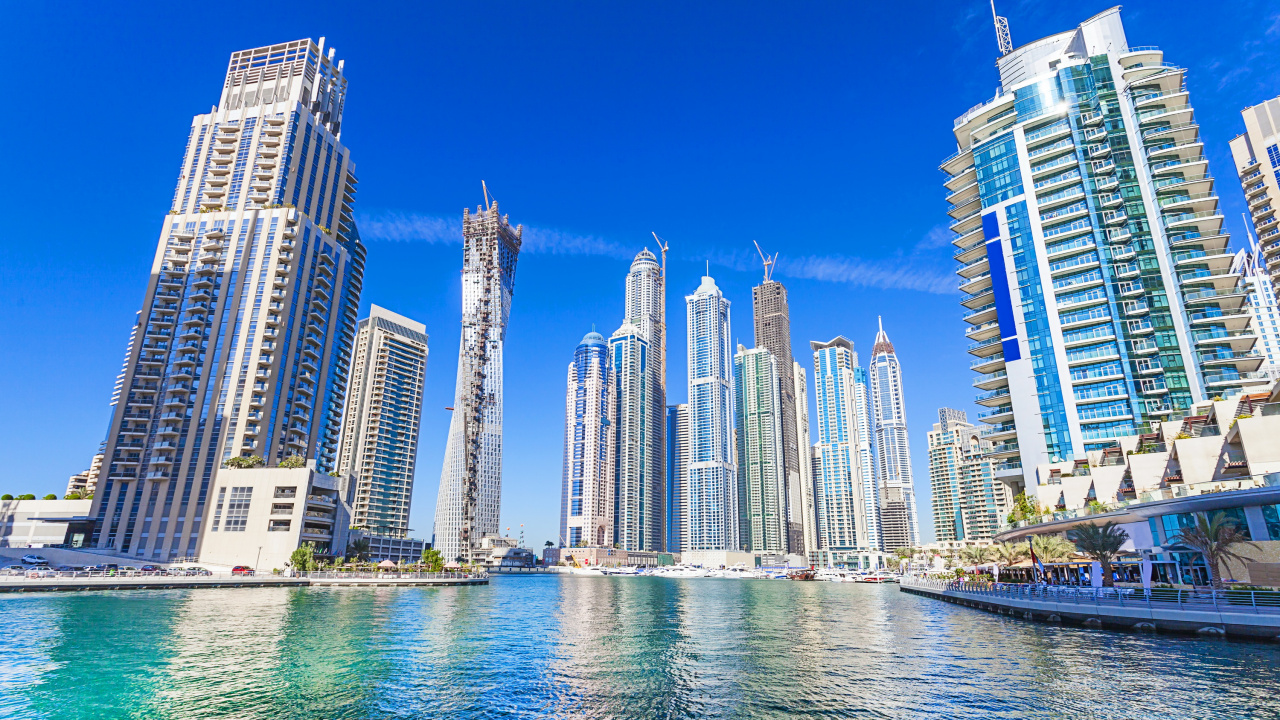 White and Blue High Rise Buildings Near Body of Water During Daytime. Wallpaper in 1280x720 Resolution