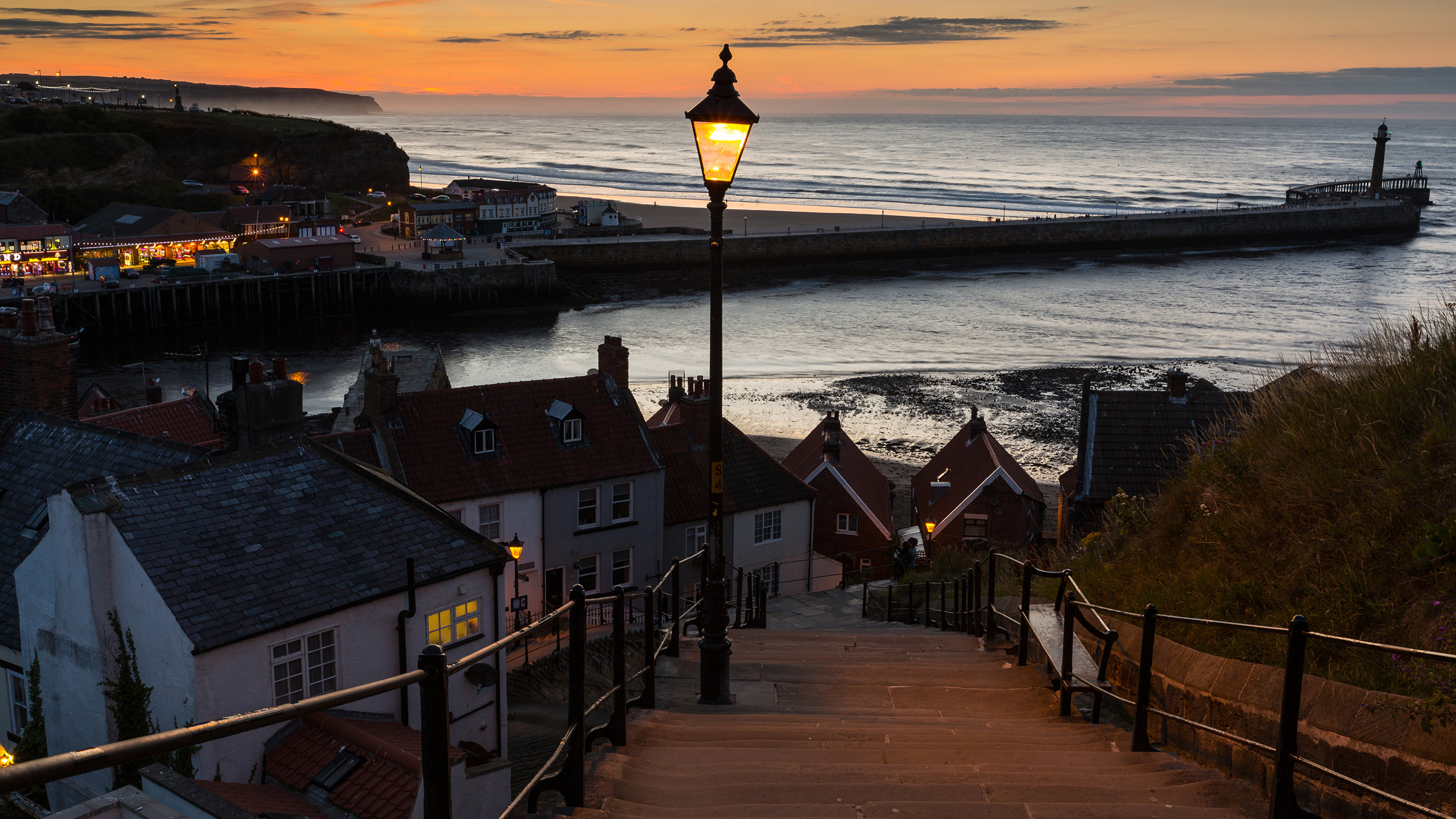 Brown Wooden Houses Near Sea During Sunset. Wallpaper in 3840x2160 Resolution