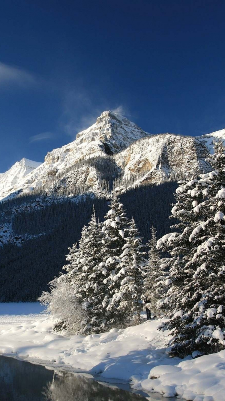 Snow Covered Mountain Under Blue Sky During Daytime. Wallpaper in 750x1334 Resolution