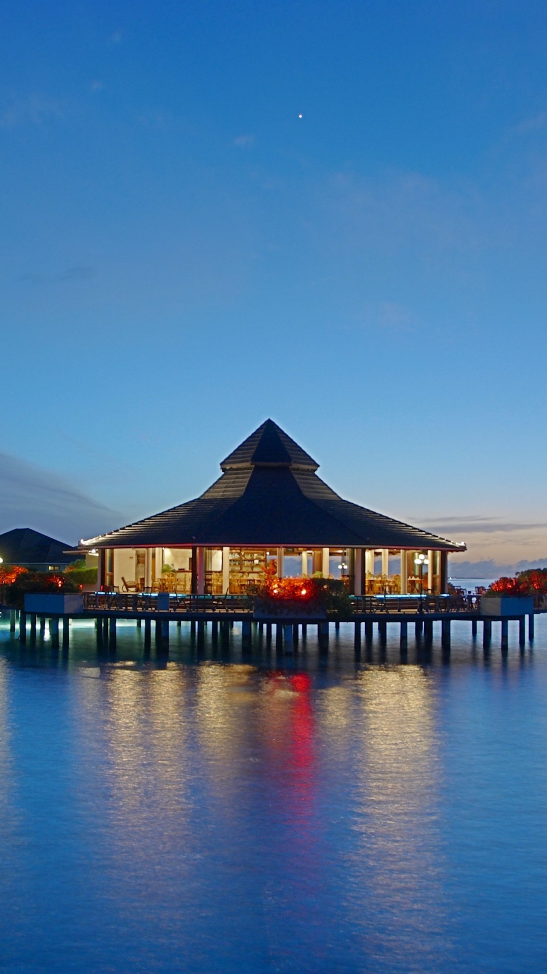 Brown Wooden Gazebo on Body of Water During Night Time. Wallpaper in 1080x1920 Resolution