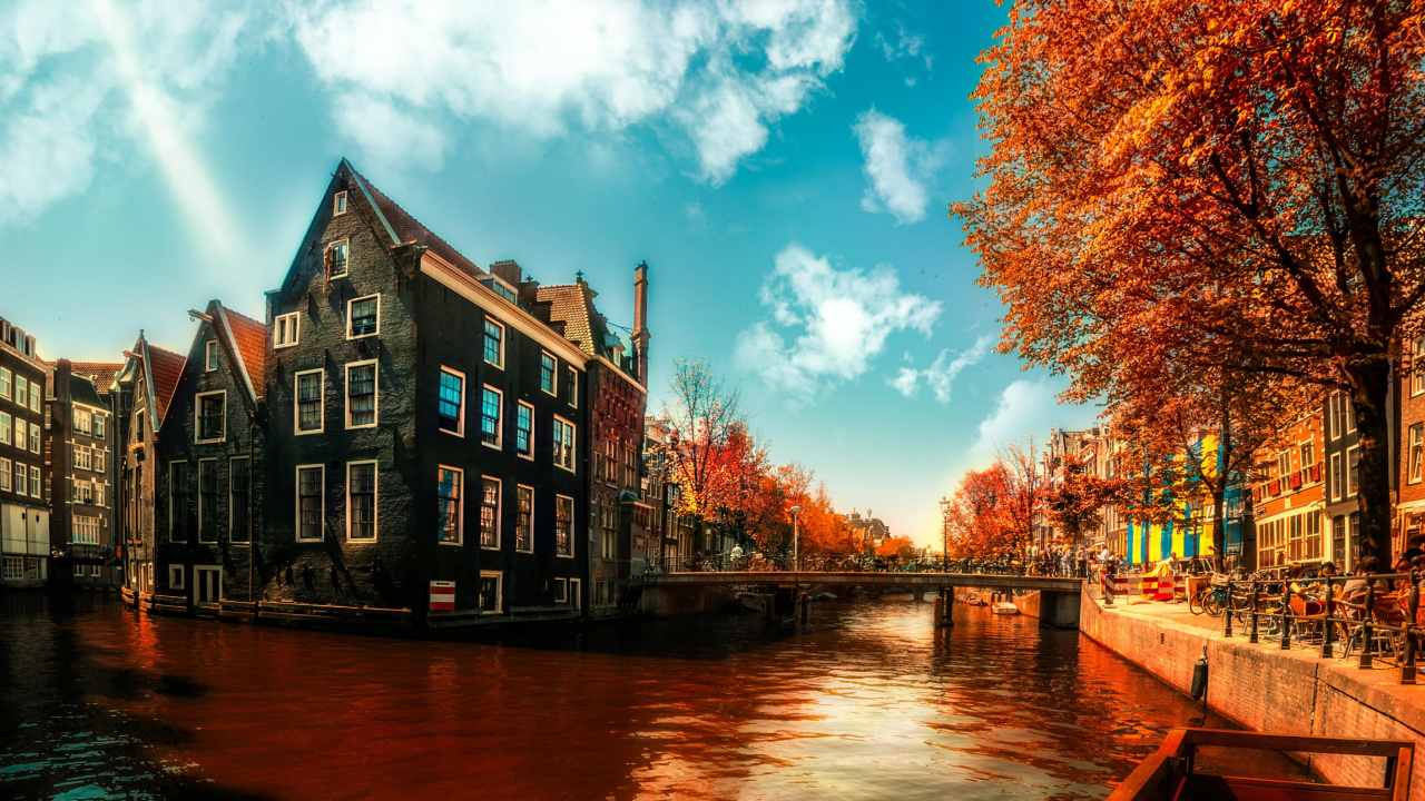 Brown and Black Concrete Building Near Body of Water Under Blue Sky During Daytime. Wallpaper in 1280x720 Resolution