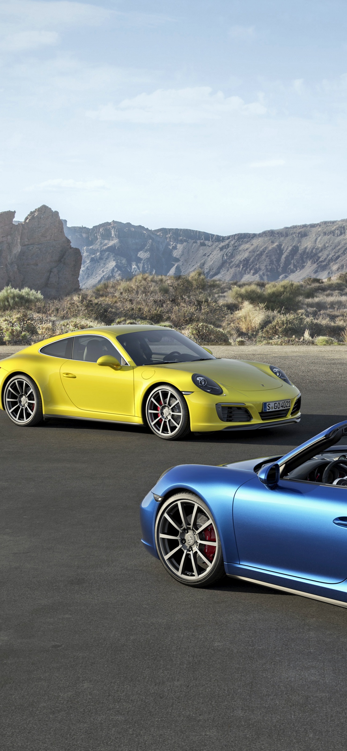 Yellow and Blue Porsche 911 on Road During Daytime. Wallpaper in 1125x2436 Resolution