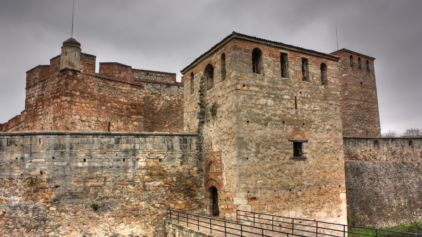 Brown Brick Building Under Cloudy Sky During Daytime. Wallpaper in 1366x768 Resolution