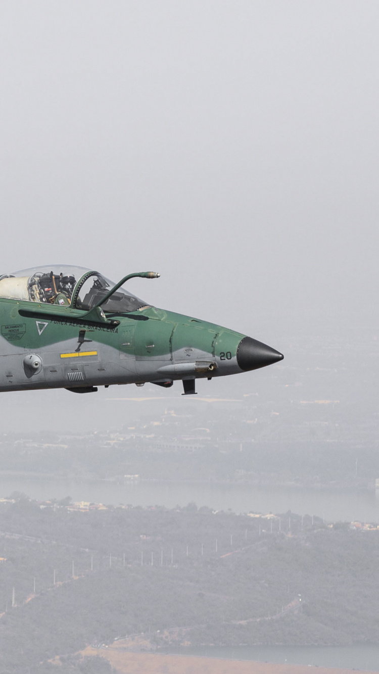 Green and Black Jet Plane Flying Over The White Clouds During Daytime. Wallpaper in 750x1334 Resolution