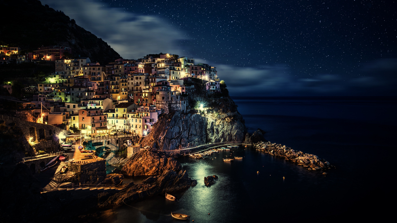 City Buildings Near Body of Water During Night Time. Wallpaper in 1366x768 Resolution