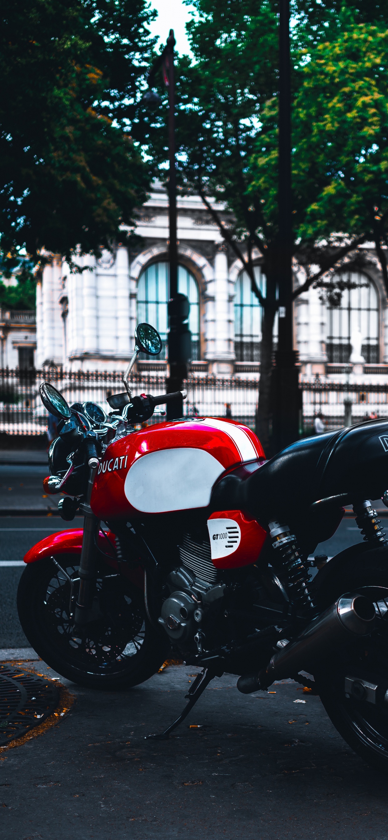 Red and Black Motorcycle Parked on Sidewalk During Daytime. Wallpaper in 1242x2688 Resolution