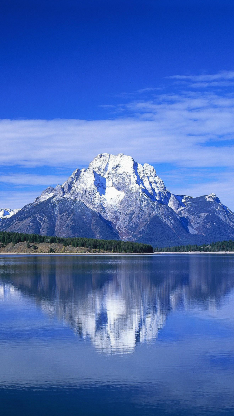 Snow Covered Mountain Near Body of Water During Daytime. Wallpaper in 750x1334 Resolution