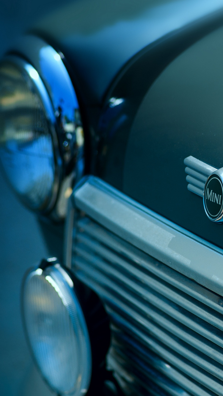 Black Car With Silver and Blue Round Pendant. Wallpaper in 750x1334 Resolution