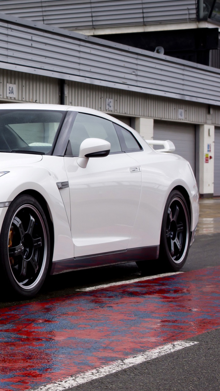 White Bmw m 3 Coupe Parked Near White Building. Wallpaper in 720x1280 Resolution