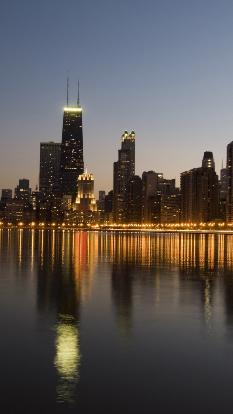 City Skyline Across Body of Water During Night Time. Wallpaper in 750x1334 Resolution