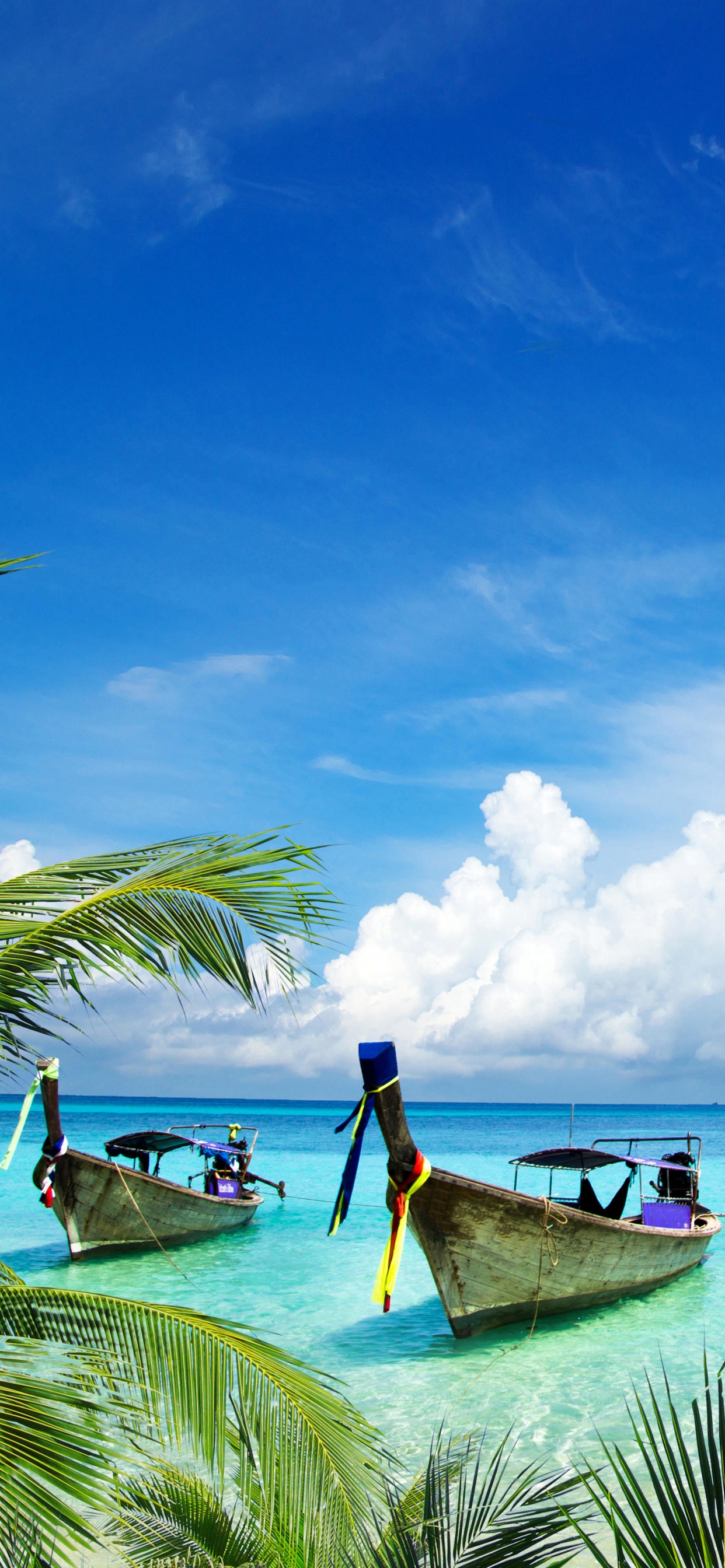 Man Sitting on Brown Wooden Boat on Sea During Daytime. Wallpaper in 1242x2688 Resolution