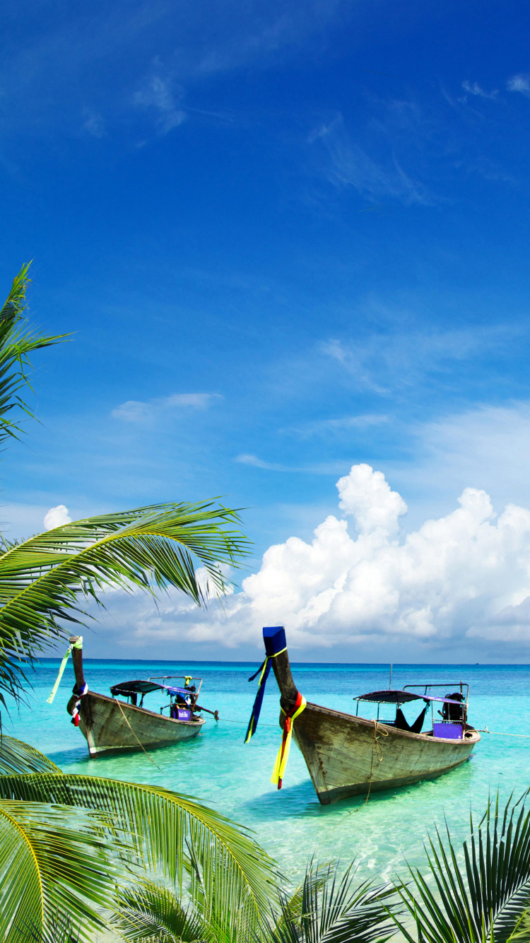 Man Sitting on Brown Wooden Boat on Sea During Daytime. Wallpaper in 750x1334 Resolution