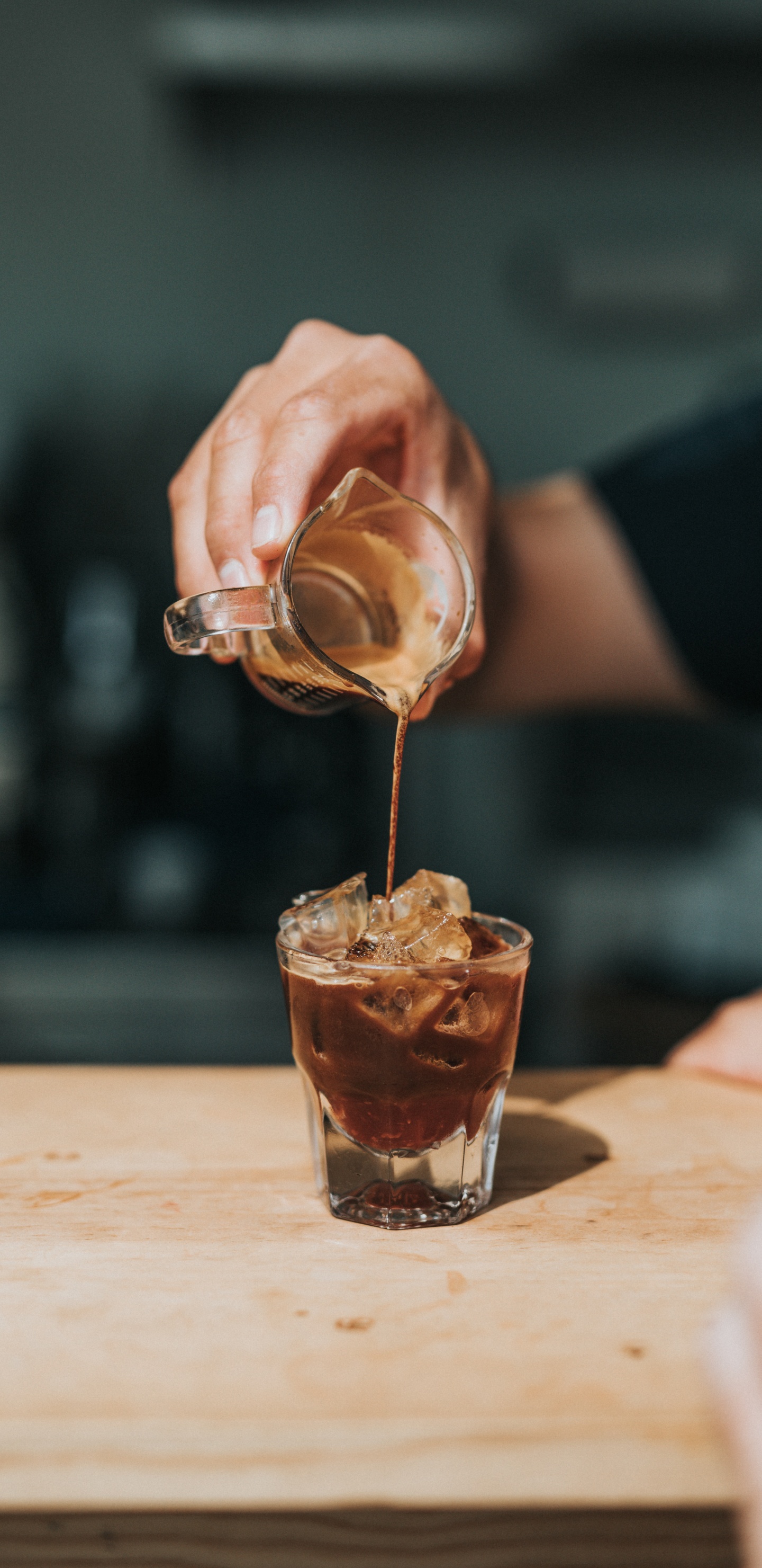 Person Pouring Brown Liquid on Clear Drinking Glass. Wallpaper in 1440x2960 Resolution