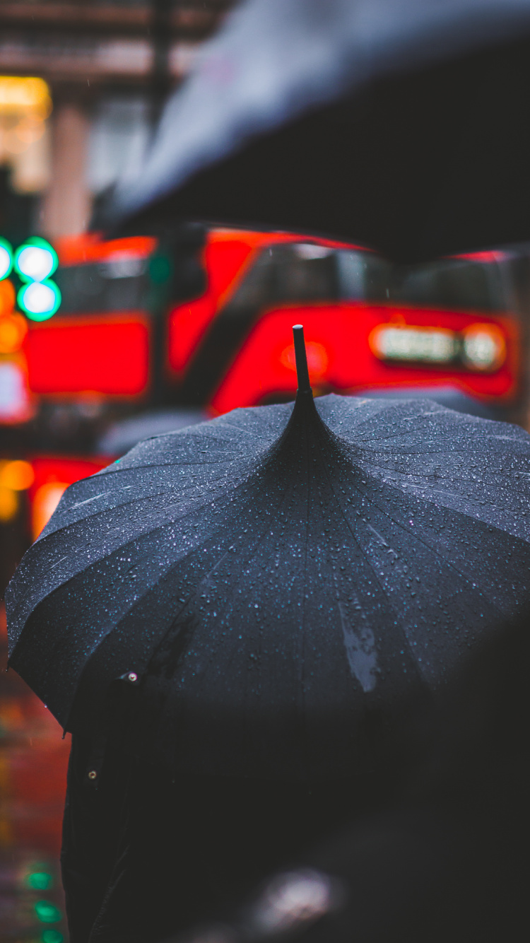 Person in Black Umbrella Walking on Street During Night Time. Wallpaper in 750x1334 Resolution