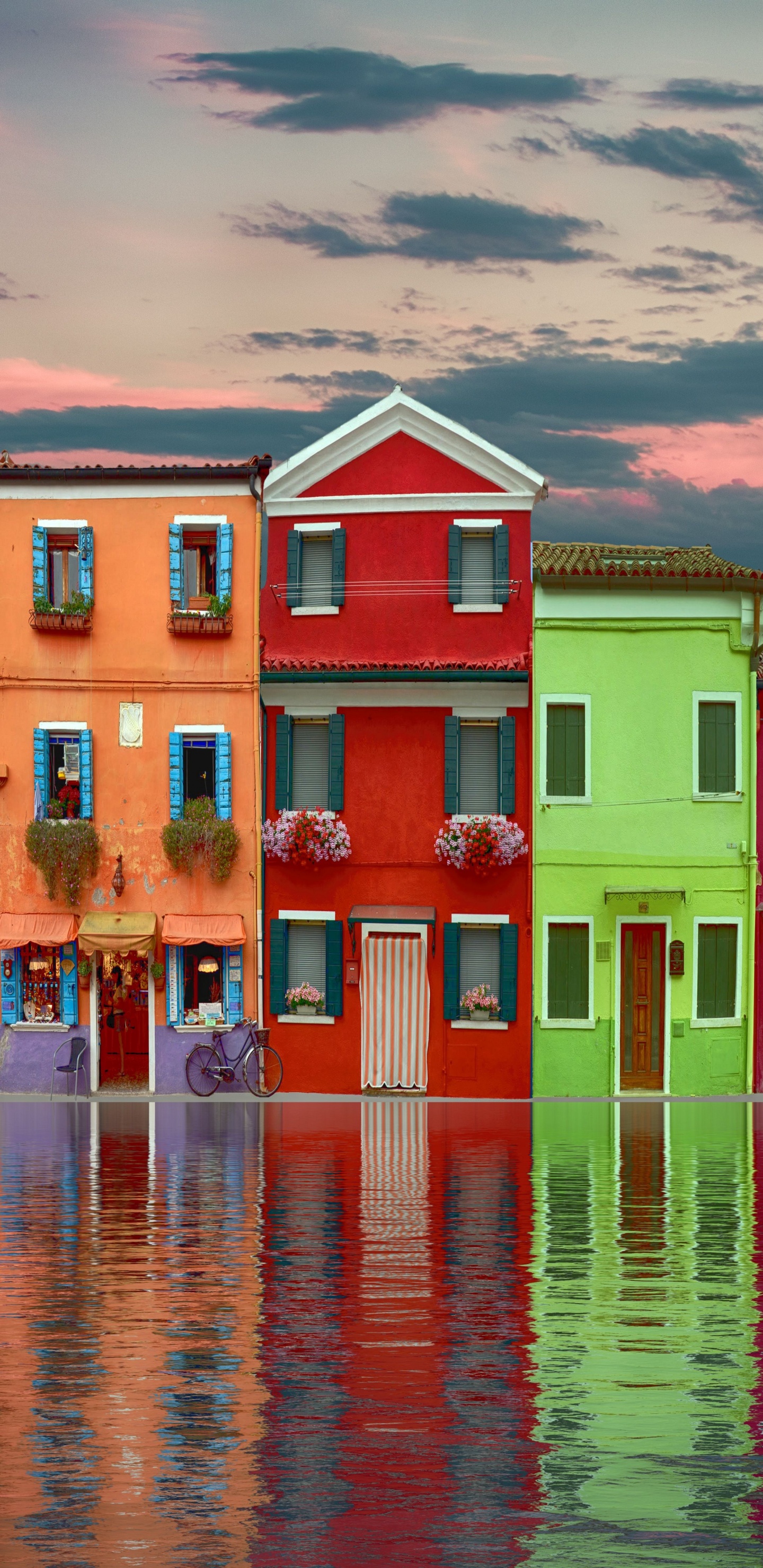 Red Green and Yellow Concrete Building Beside Body of Water During Daytime. Wallpaper in 1440x2960 Resolution